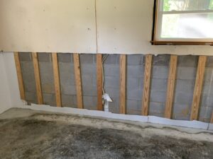 Drywall removed to expose concrete block and studs during water damage remediation by Stovall's Surface Solutions LLC in Elizabethtown, KY.