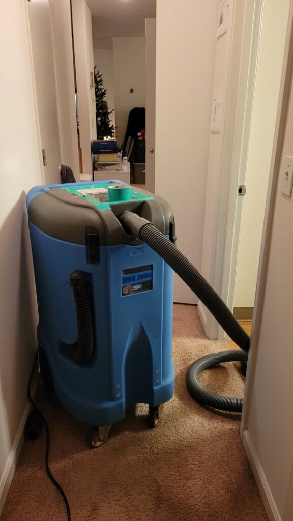 A large blue water damage extractor machine placed in a hallway for drying by Robinson Restoration in Vancouver, WA