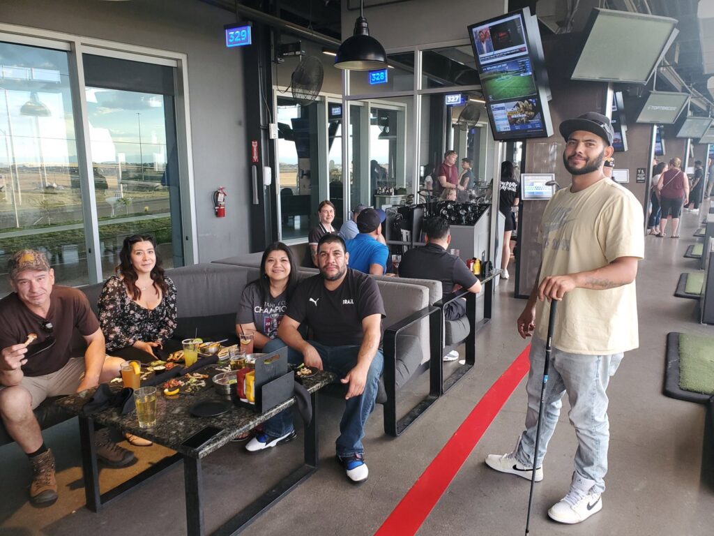 Water Damage, Inc. van with a hose running into a building for water extraction or drying services in Denver, CO.