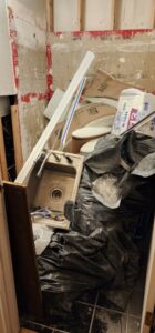 A room undergoing water damage remediation with stripped walls and debris removal by TCM Restoration & Cleaning in Anchorage, AK.