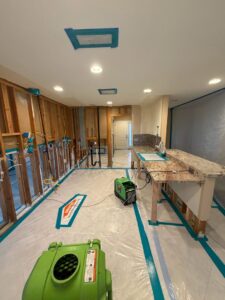 A room with exposed studs and drying equipment during water damage remediation by Servpro of Sandy in Sandy, UT.