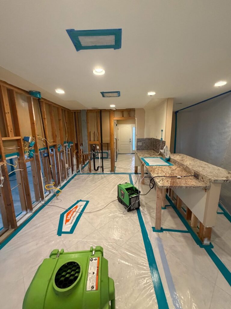 A room with exposed studs and drying equipment during water damage remediation by Servpro of Sandy in Sandy, UT.
