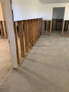 A room undergoing water damage remediation with drywall removed and studs exposed by Quick Response in Las Vegas, NV.