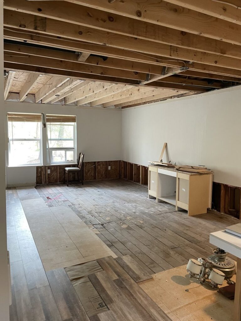 A room undergoing water damage remediation with lower walls removed and subfloor exposed by L&J Construction Inc in Middletown, NY