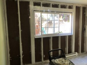 A room undergoing water damage remediation with walls stripped down to the studs, showing the restoration process by One Call Services of Oakland in Oakland, CA.