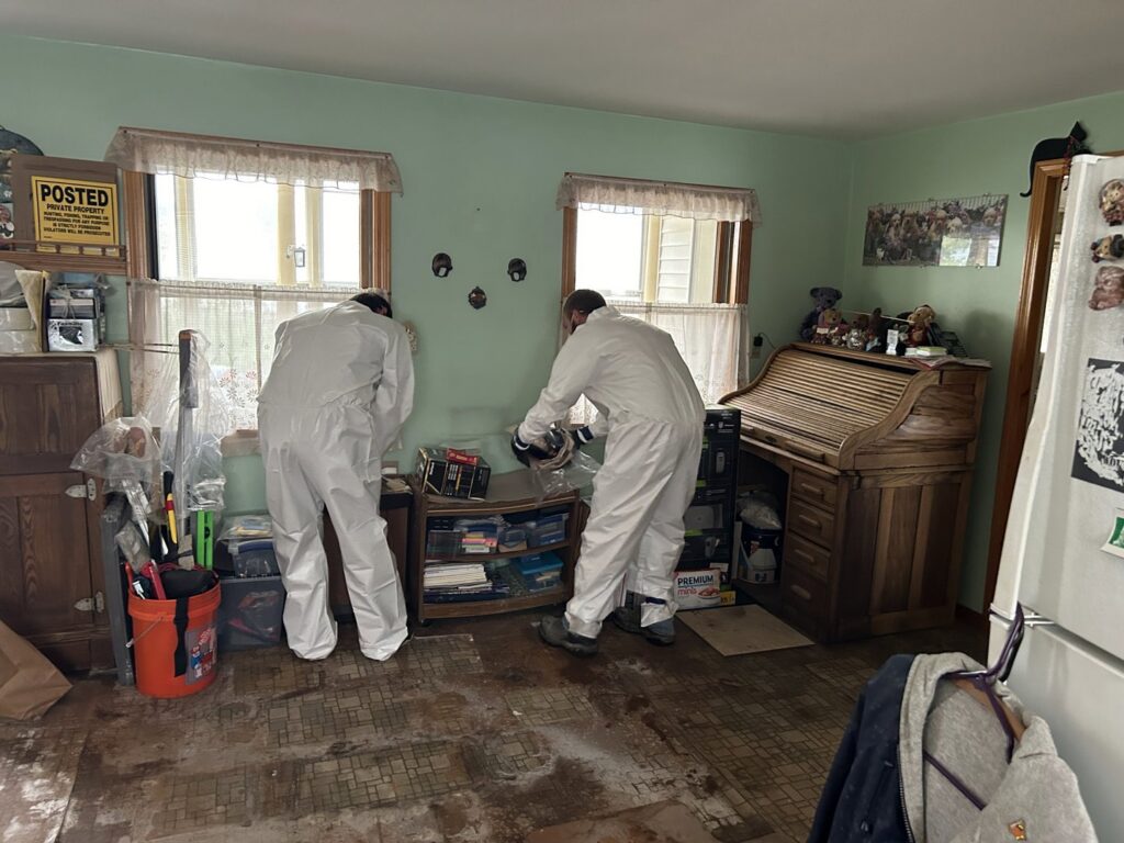 Gold Star Services LLC crew in hazmat suits performing water damage restoration in a room in Newark, DE
