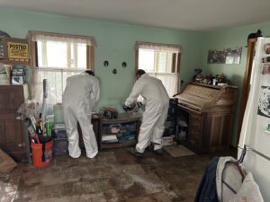 Gold Star Services LLC crew in hazmat suits performing water damage restoration in a room in Newark, DE