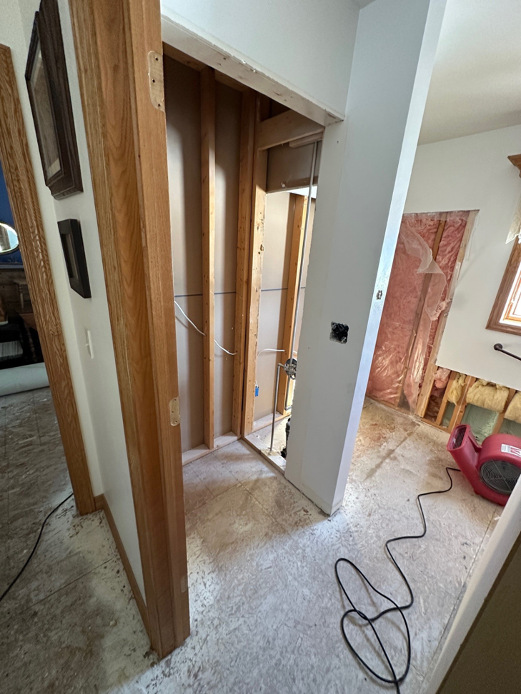 An air mover drying a room during water damage restoration by R Van Rite Construction & Restoration in Hobart, WI
