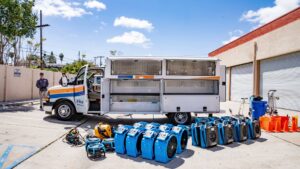 A wide array of water damage restoration equipment, including many air movers, displayed by Certified Restoration in San Diego, CA