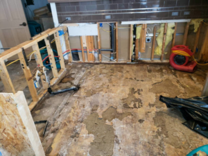 A kitchen undergoing water damage restoration with drying equipment by Certified Professional Restoration in Simpsonville, SC.