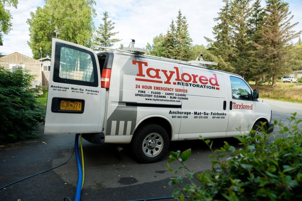 A Taylored Restoration van with hoses deployed for water damage restoration in Anchorage, AK