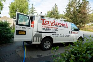 A Taylored Restoration van with hoses deployed for water damage restoration in Anchorage, AK