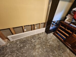 Interior showing exposed studs and concrete floor, indicating water damage restoration work by Pile's Carpet Care & Restoration Service in Elizabethtown, KY.