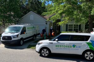 Restored Air water damage specialists arriving at a residential job site with equipment in Summerville, SC.