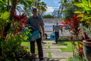 Water damage specialists carrying drying equipment to a residential property for Premier Restoration Hawaii in Honolulu, HI.