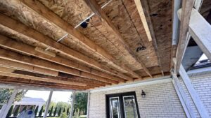 Water-stained wood sheathing under a porch, showing damage requiring specialist repair by Patriot's Handyman and Remodeling in Richmond, KY.