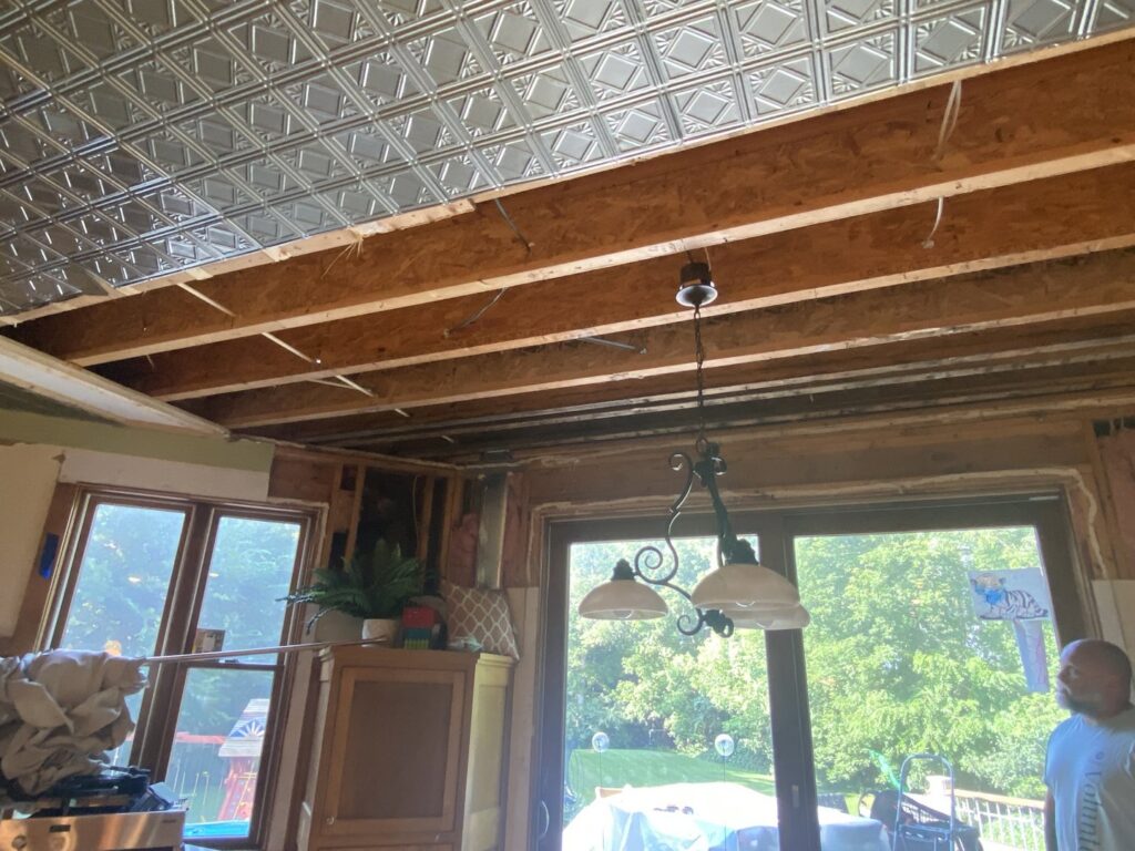 A water-damaged ceiling with exposed joists and subfloor during restoration by ServiceMaster DSI in Maple Grove, MN.