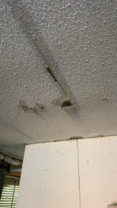 A water-damaged ceiling with discoloration and peeling, indicating a job for Minutemen Property Damage Services in North Charleston, SC.