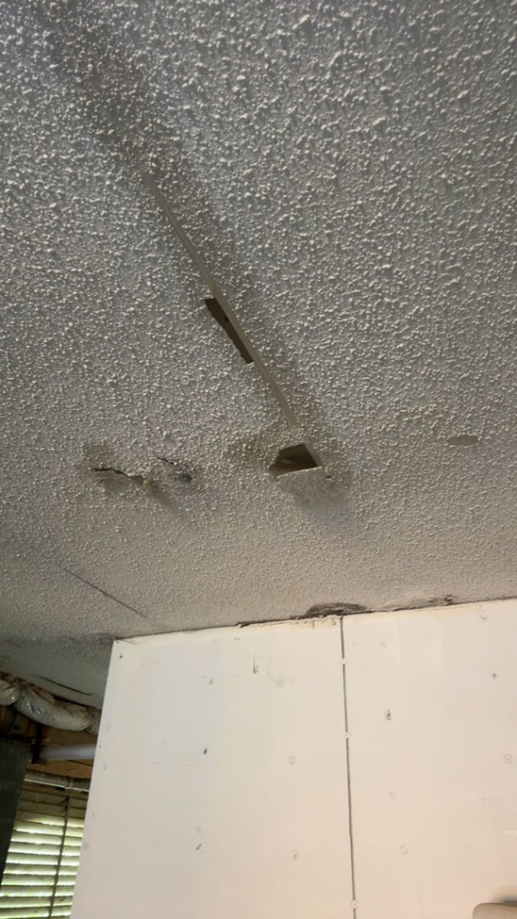 A water-damaged ceiling with discoloration and peeling, indicating a job for Minutemen Property Damage Services in North Charleston, SC.