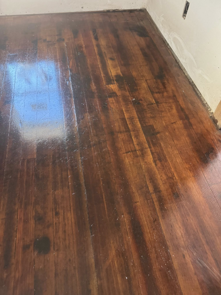A hardwood floor showing clear signs of water damage, ready for repair by Highway Renovation in Twin Falls, ID.