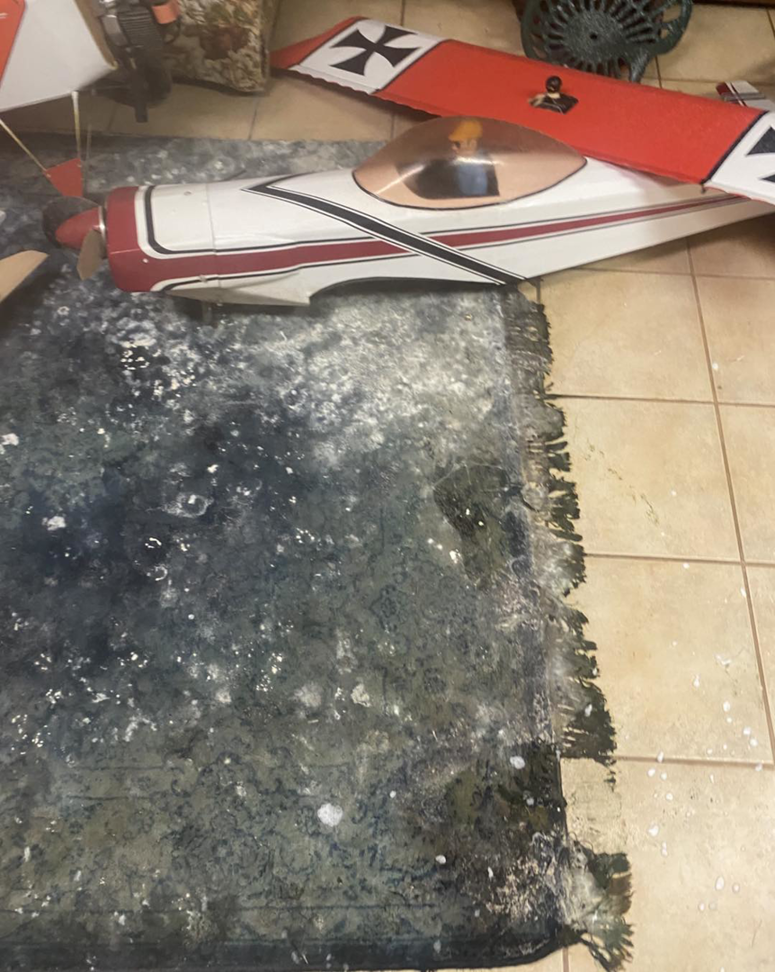 A severely water-damaged and moldy carpet on a tiled floor, showing the need for restoration by 24HR Flood Pros of OKC in Oklahoma City, OK.