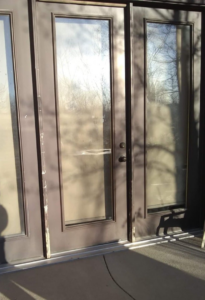 Exterior patio doors showing peeling paint and water damage, restored by R&R Residential Restoration & Customization in Casper, WY.
