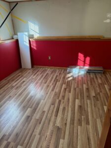 A room with exposed studs and multiple drying machines for water damage restoration by Remont Restoration in Hagerstown, MD.