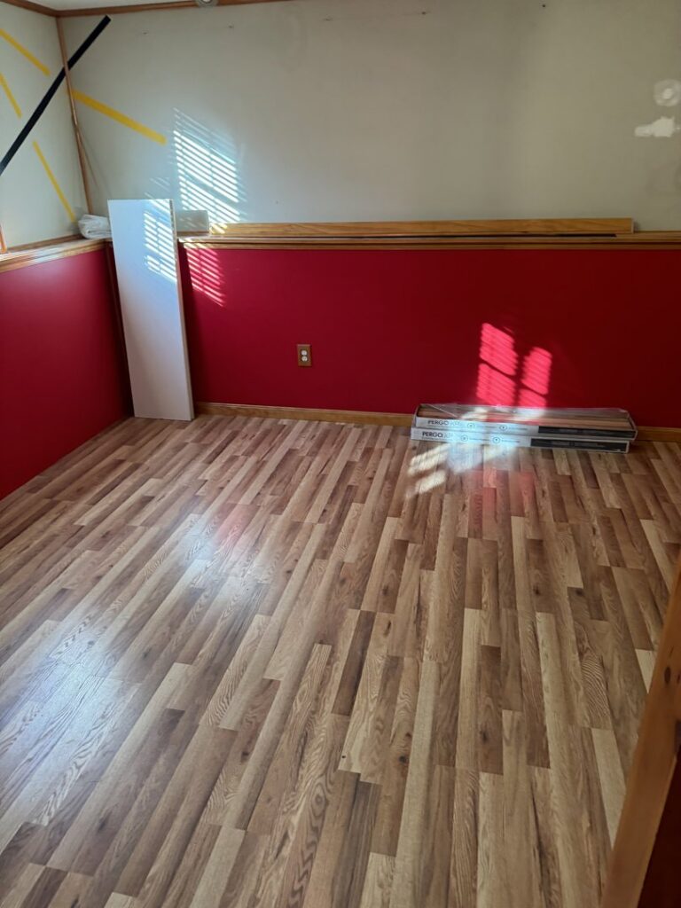 A room with exposed studs and multiple drying machines for water damage restoration by Remont Restoration in Hagerstown, MD.