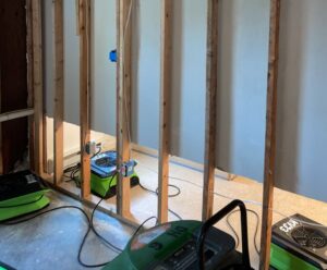 A water-damaged room with walls removed and SERVPRO of Barre, Montpelier drying equipment running in Barre, VT.