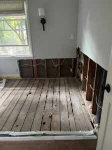 Demolition of water-damaged walls and flooring, exposing studs and pipes, by Ungerman, Inc. in Plymouth, MN