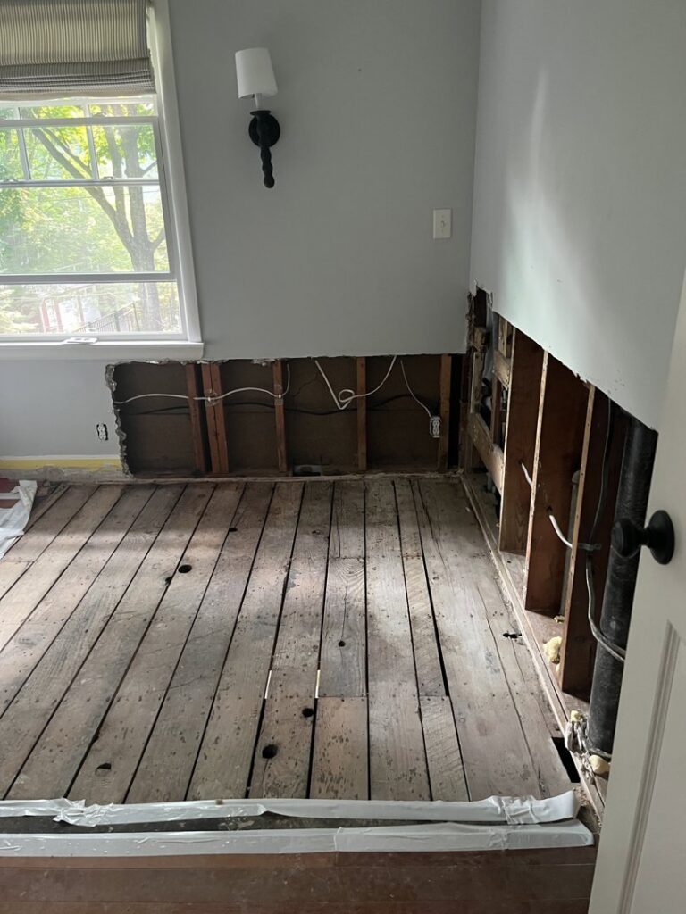 Demolition of water-damaged walls and flooring, exposing studs and pipes, by Ungerman, Inc. in Plymouth, MN