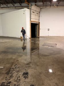 A Paul Davis Restoration of Greater Portland, ME worker performing water extraction and cleanup on a flooded floor in Falmouth, ME.