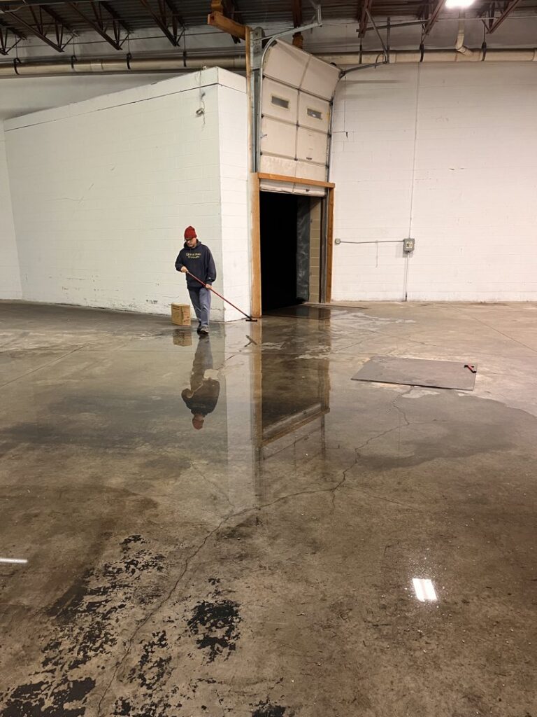 A Paul Davis Restoration of Greater Portland, ME worker performing water extraction and cleanup on a flooded floor in Falmouth, ME.