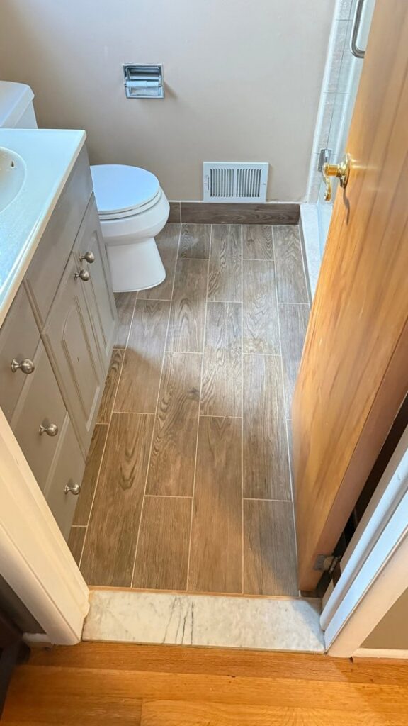 A water damage specialist performing water extraction in a room with exposed wall studs after water damage demolition for H2O Pros Water Restoration Services in Westland, MI.