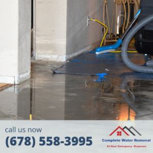 Water extraction equipment being used on a floor with standing water by Complete Water Removal and Restoration in Cumming, GA.