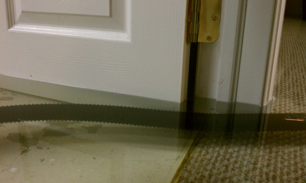 Water extraction in progress from a flooded room with wet carpet by Water Damage Squad in Philadelphia, PA.