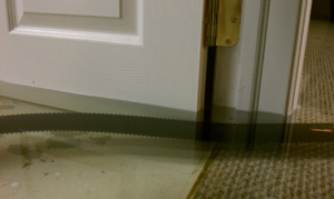 Water extraction in progress from a flooded room with wet carpet by Water Damage Squad in Philadelphia, PA.