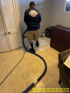 A water damage specialist performs water extraction on a flooded floor at Directed Heat Restoration in Livonia, MI.
