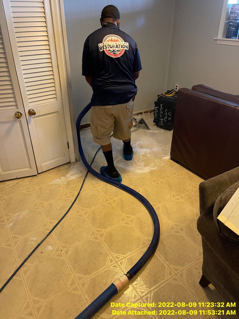 A water damage specialist performs water extraction on a flooded floor at Directed Heat Restoration in Livonia, MI.