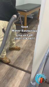 A technician performing water extraction services on a floor for Restoration 1 of Birmingham in Pelham, AL.
