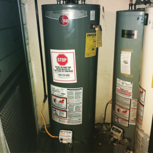 A water heater with visible signs of leakage and water damage on the floor, being assessed by Bulleit Renovation & Repair in Oakland, CA.
