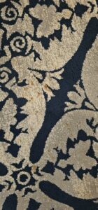 Close-up of a patterned carpet showing brown water stains, indicating a need for water damage restoration by COIT Cleaning and Restoration in Indianapolis, IN