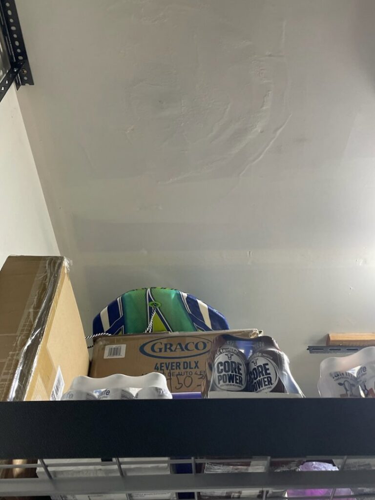 Visible water stains on a ceiling in a garage or storage area, indicating water damage handled by RestoPros of Salt Lake City, UT