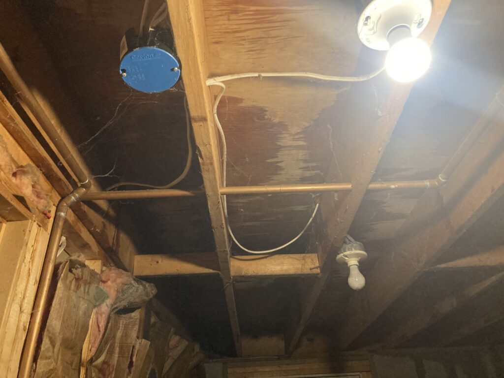 Clear water stains visible on wooden ceiling joists, indicating water damage addressed by Gold Star Services LLC in Newark, DE