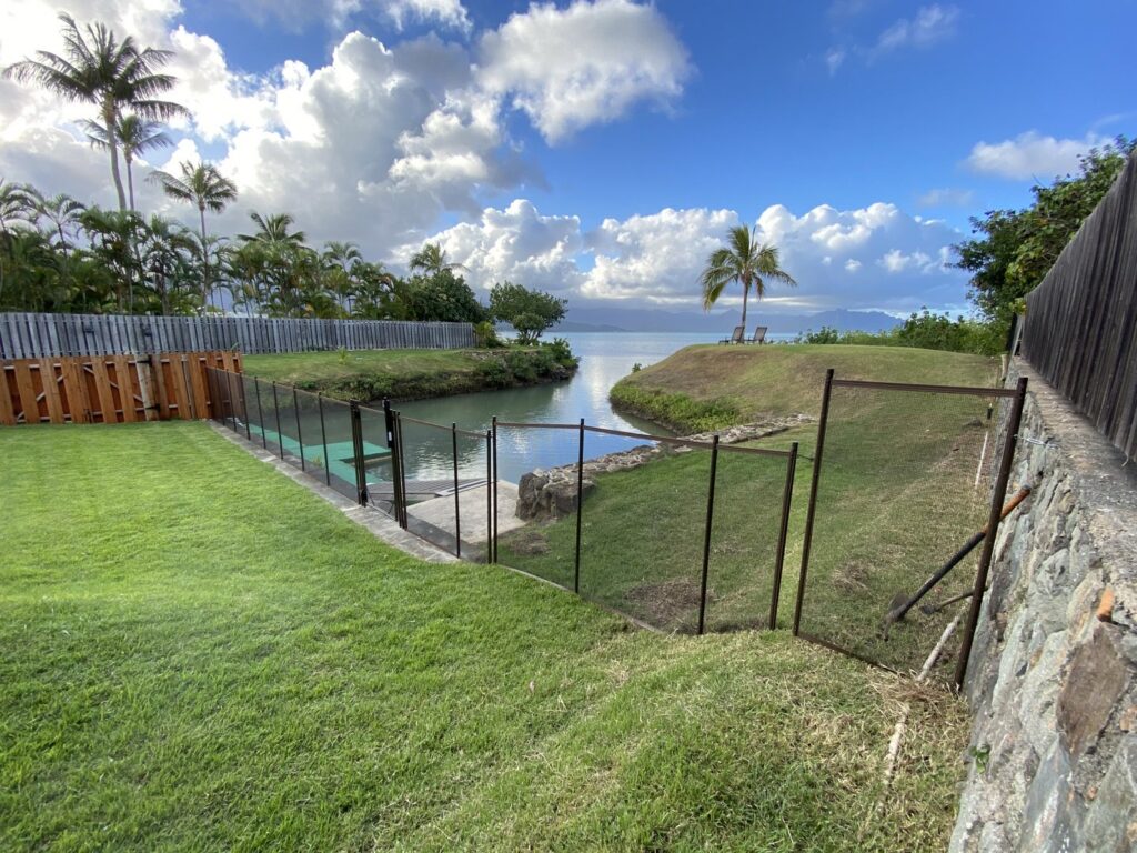 A waterfront pool fence installation by Guardian Pool Fence Systems of Hawaii, providing safety for a pool near the bay in Honolulu, HI.