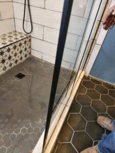 Well pressure tank and plumbing showing signs of a leak and water stains on the floor by Affordable Plumbing Expert in Edmond, OK