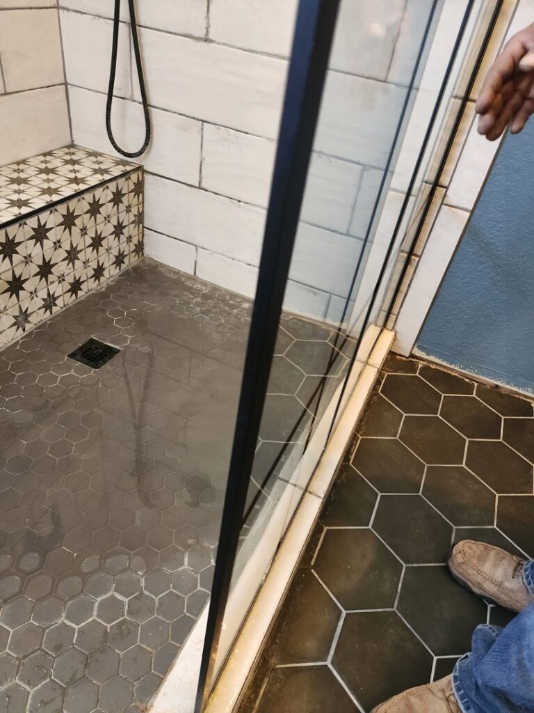 Well pressure tank and plumbing showing signs of a leak and water stains on the floor by Affordable Plumbing Expert in Edmond, OK