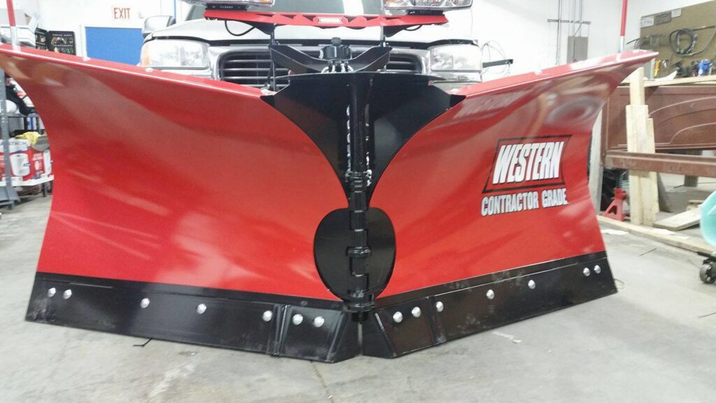 A red Western Contractor Grade snow plow attachment, ready for snow removal services by Yakima Landscape Management in Yakima, WA.