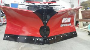 A red Western Contractor Grade snow plow attachment, ready for snow removal services by Yakima Landscape Management in Yakima, WA.