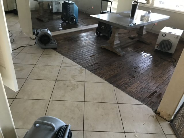 Wet tiled and wood flooring with air movers for water damage drying by Best Dry Flood and Mold Specialists, Inc. San Diego, CA